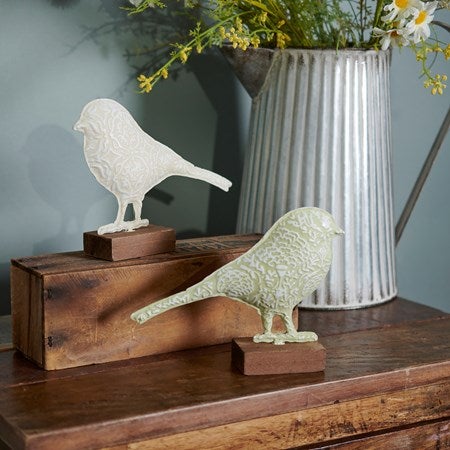 Metal bird on wood stand